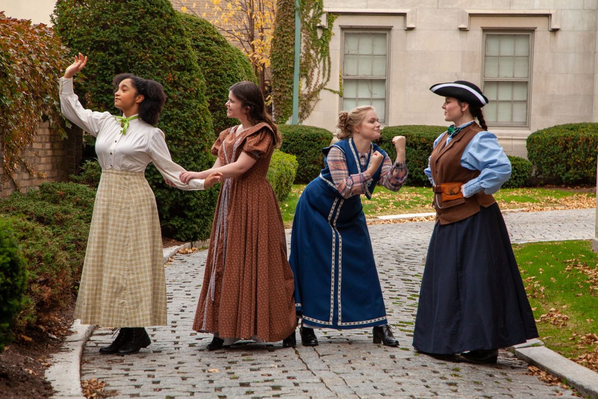 the cast of little women in civil war era costumes in front of the weckesser annex