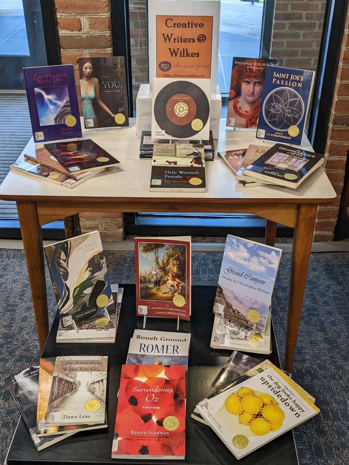 library display of books written by creative writing faculty and students